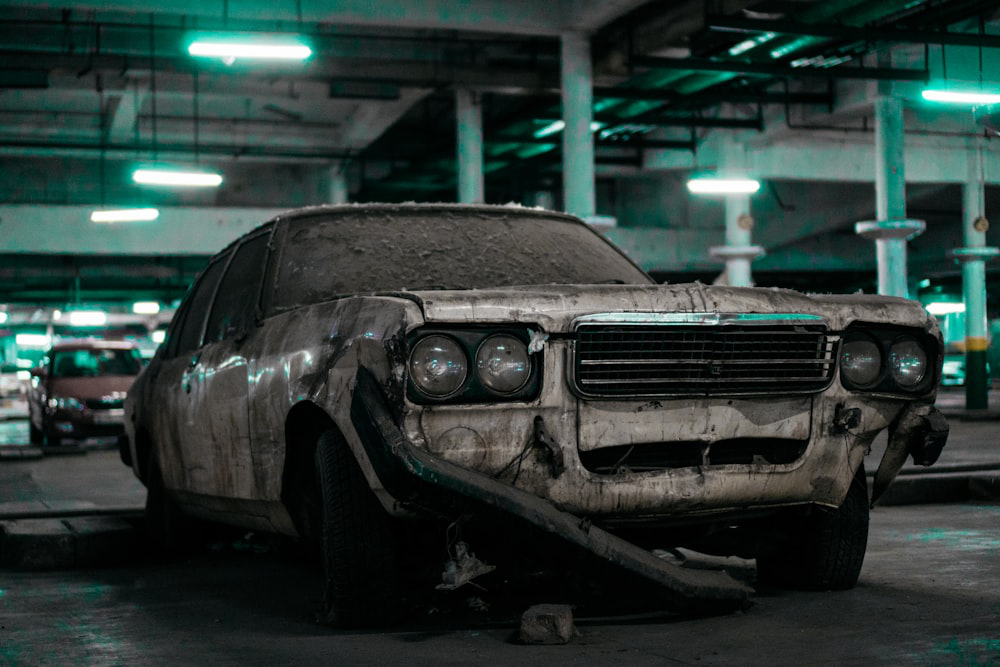 A junk car parked in a salvage yard