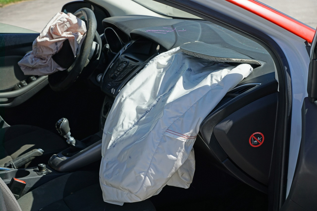 Deployed airbags in a car interior.