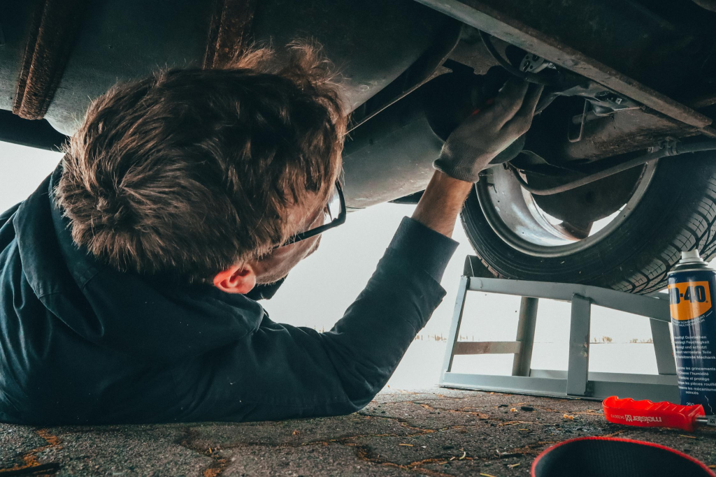 A mechanic fixing a car engine.